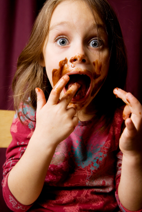 girl-eating-chocolate "Food that contains too much sugar, like candy, leads to acid formation. That, in turn, causes cavities."